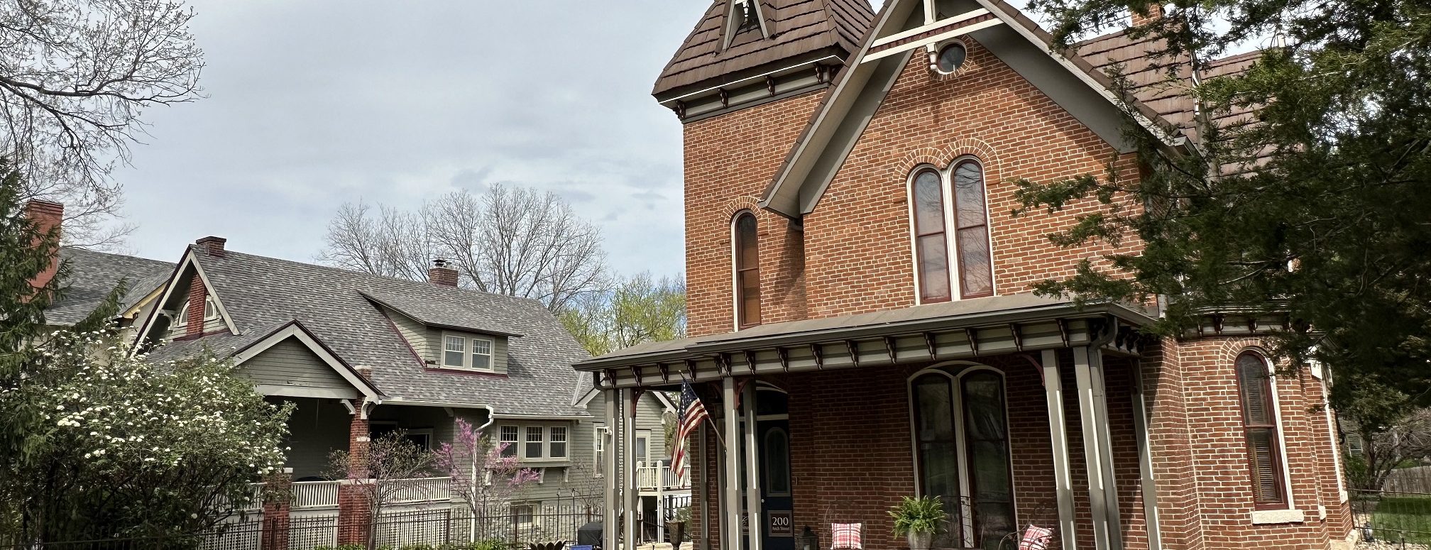 A brick Victorian home on a tree-lined street in the Arch Street Historic District, Leavenworth
